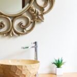 Brown bathroom decor with a warm wooden vanity and mirror