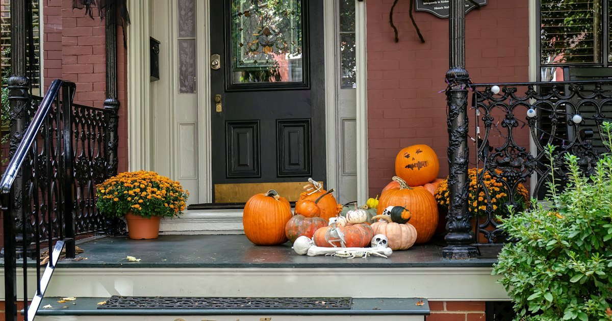 Fall door decor progression with pumpkins and gourds styled on a front porch