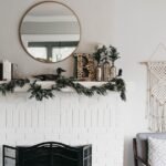 Fall mantel decorating ideas on a white fireplace mantel with layered decor and warm accents