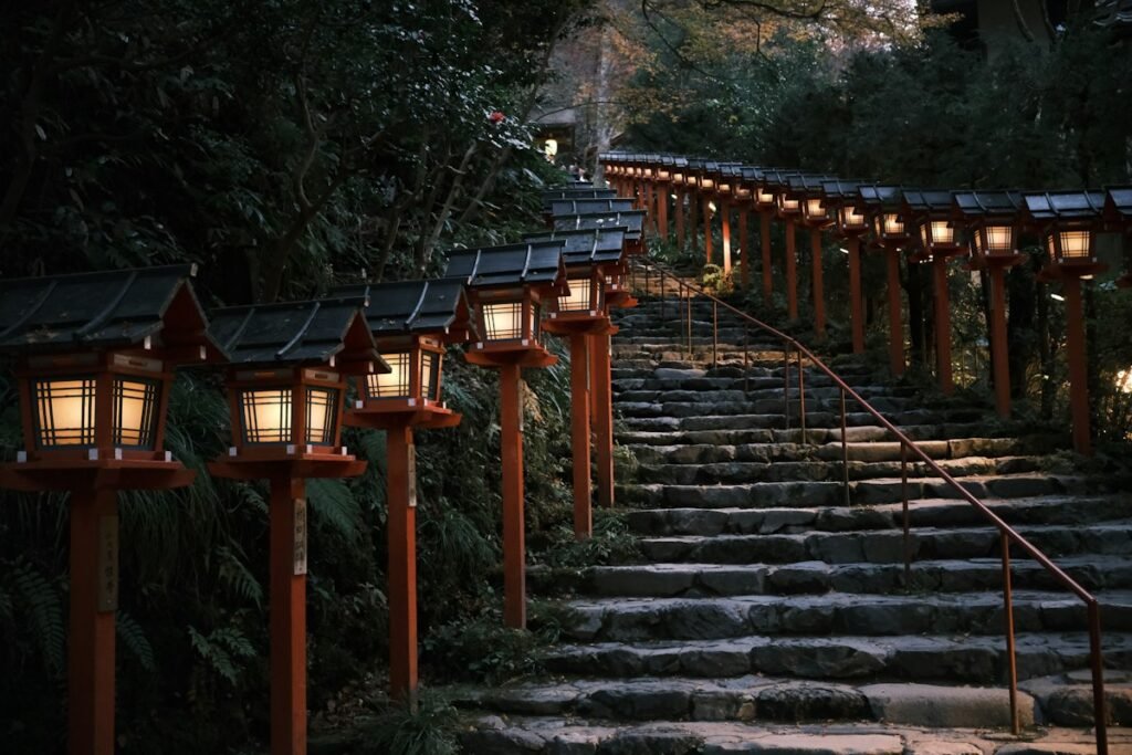 Stone stairs lined with glowing lanterns at dusk