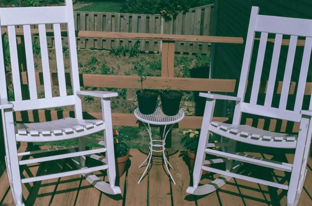 White wooden rocking chair on a wooden deck