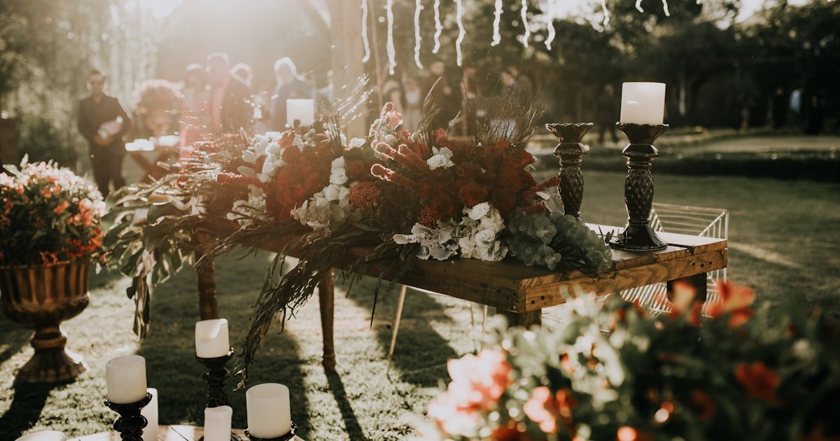 Wedding decor checklist essentials with floral centerpieces and candle holders on a reception table