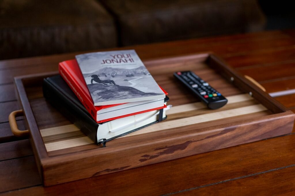 Stack of books on a wooden tray