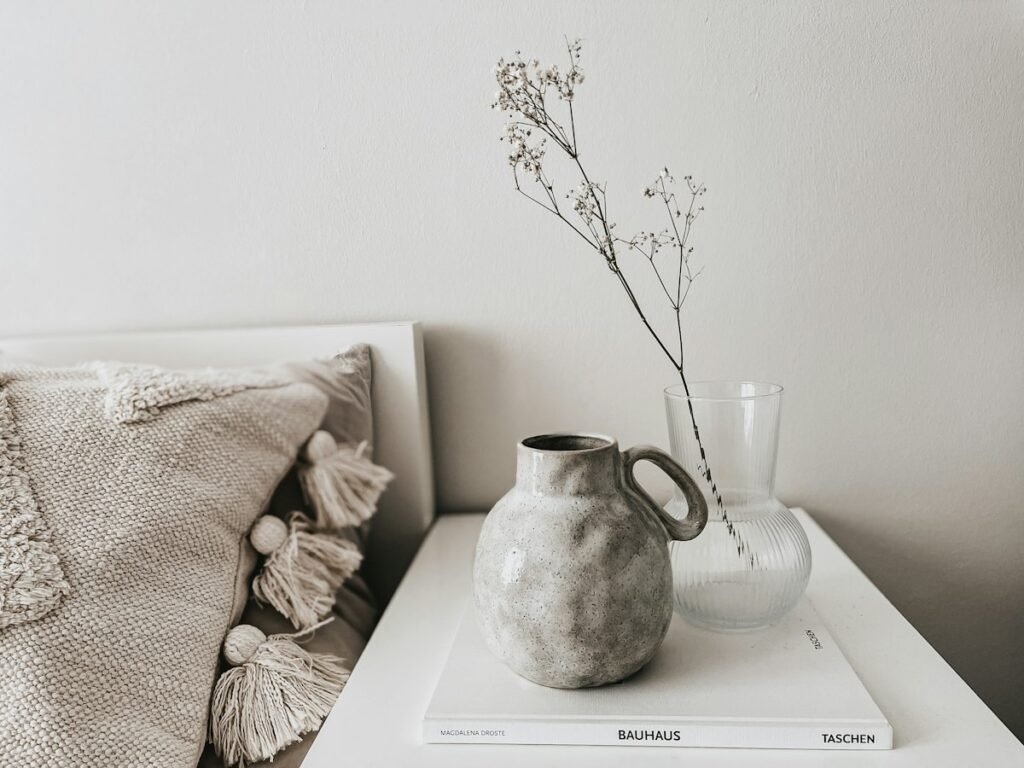 White ceramic vase standing on a book