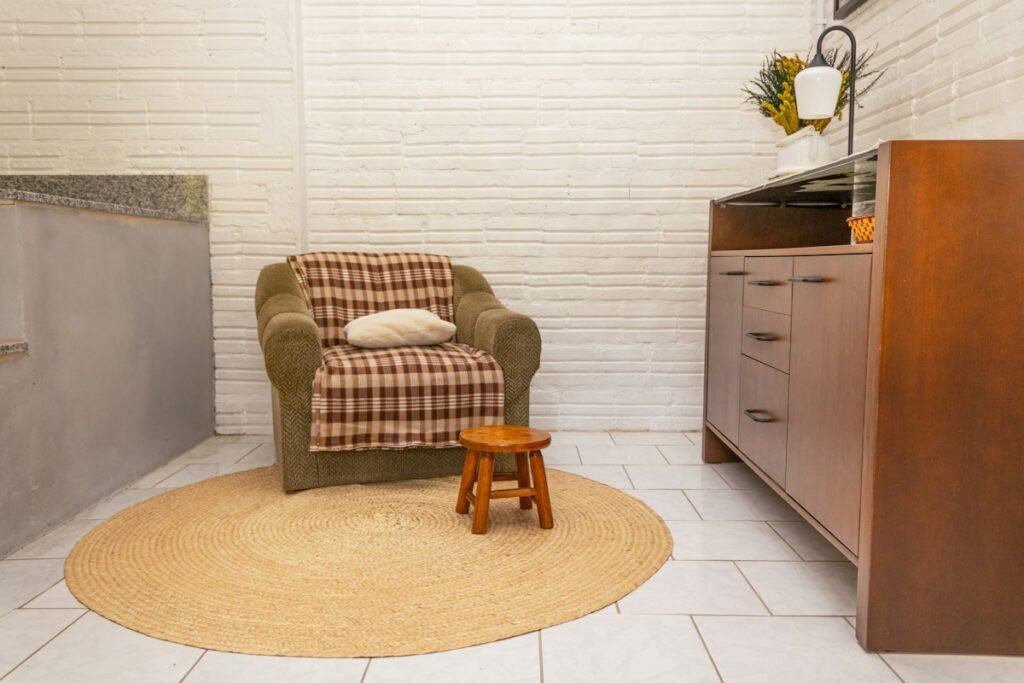 Armchair with a blanket and a stool on a rug