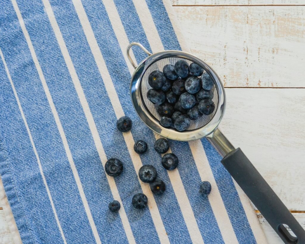 Bowl of blueberries on a blue and white towel