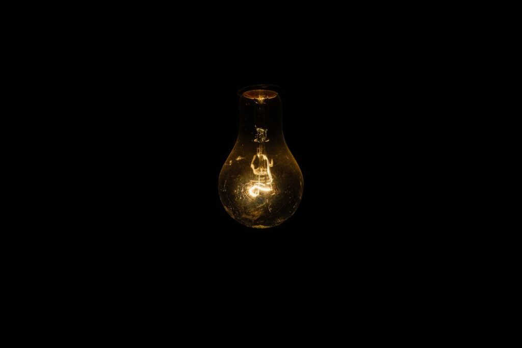 Close-up of a lit warm-white light bulb