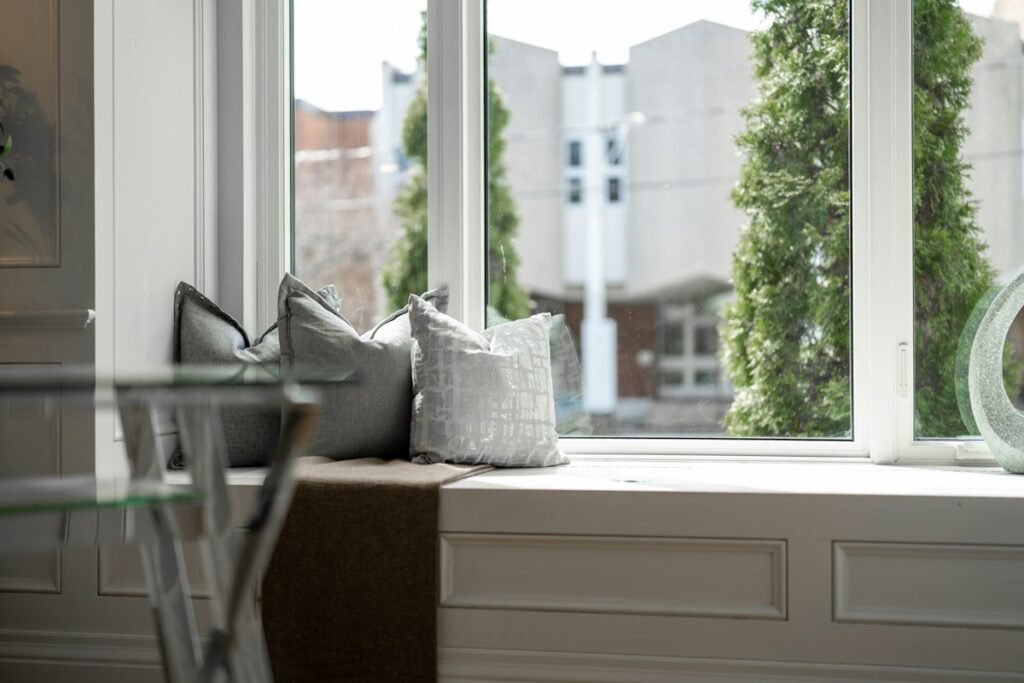 Two decorative pillows on a window seat
