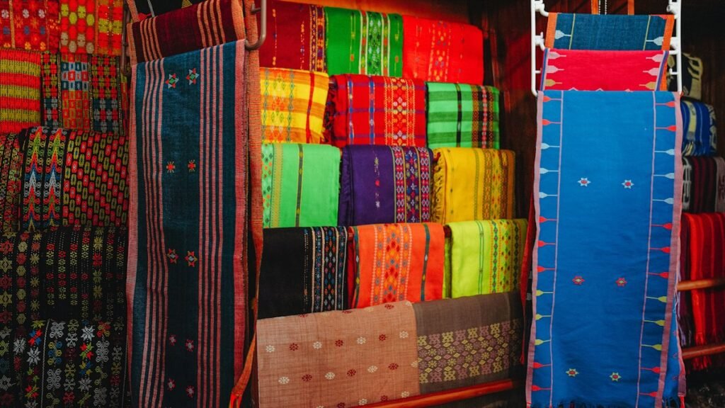 Colorful woven textiles displayed at a market stall