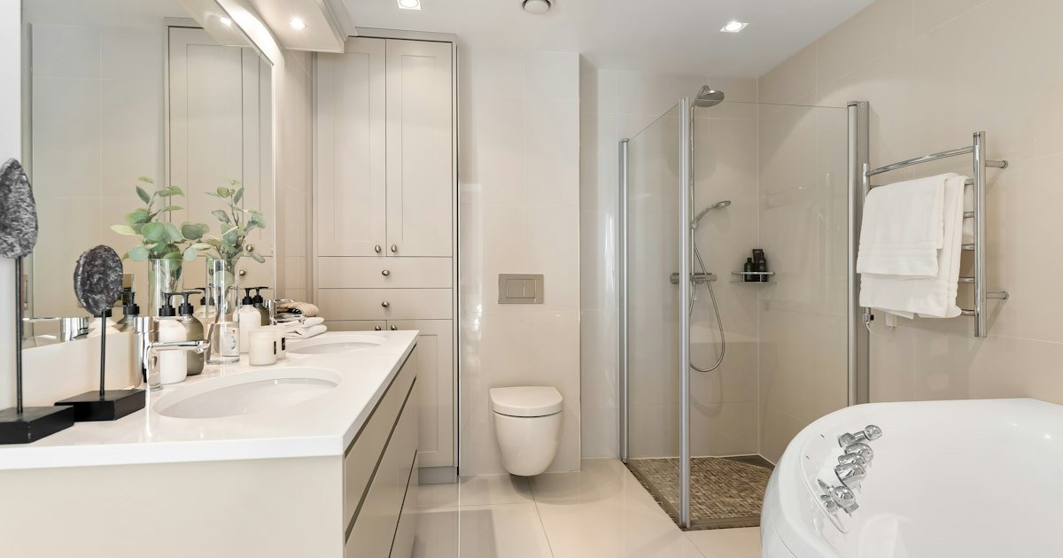 White bathtub beside a pedestal sink