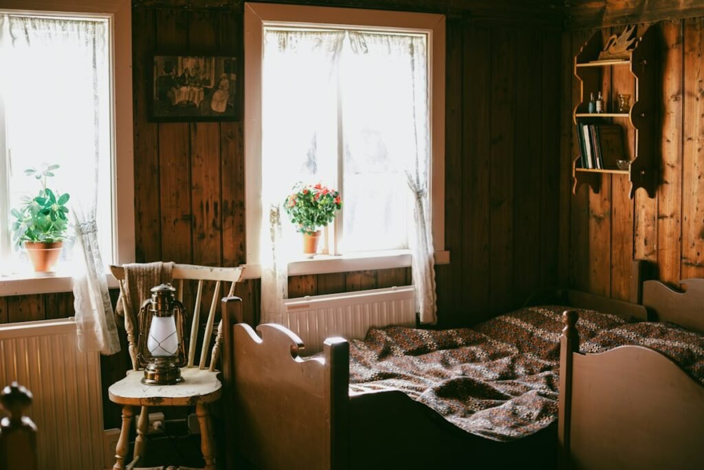 Rustic bedroom with wooden walls, a bed and a lantern