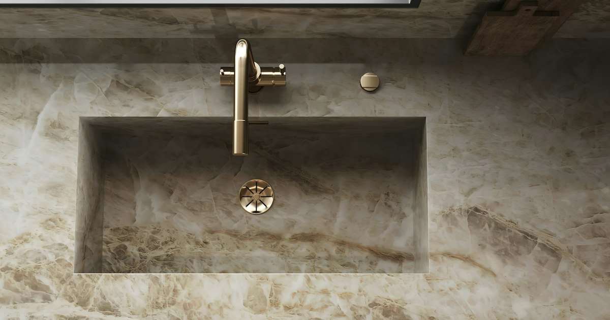 Gold bathroom decor with a brushed gold faucet and mirror