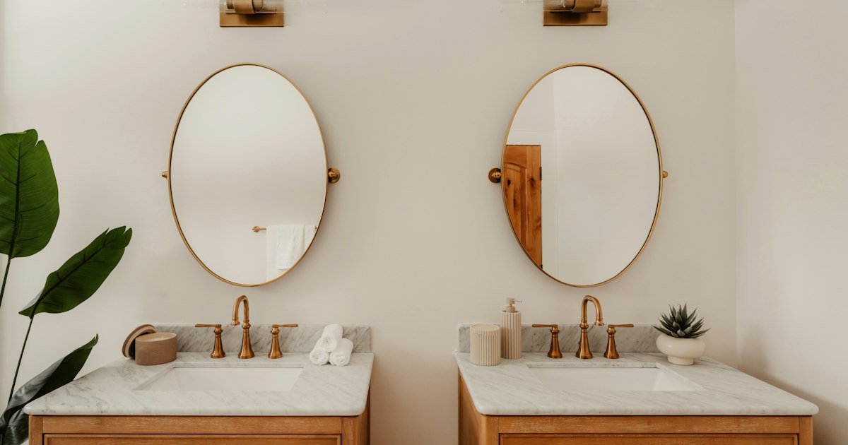 Two wooden vanities with brushed gold fixtures