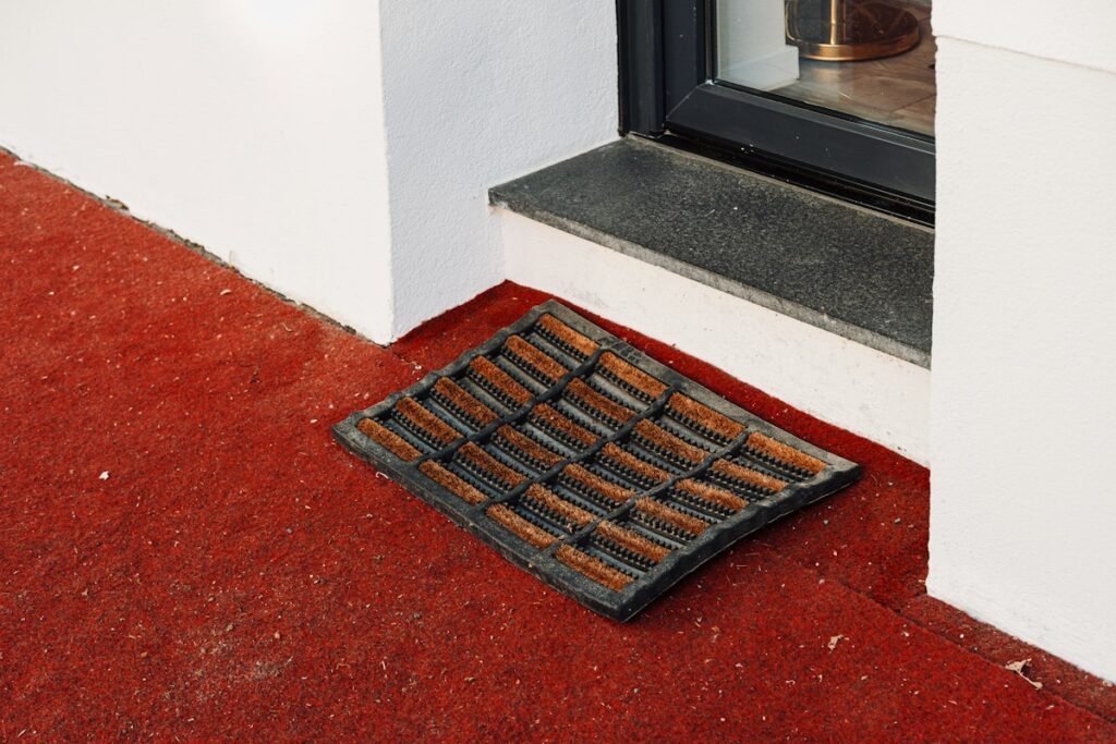 Doormat on the floor beside a door