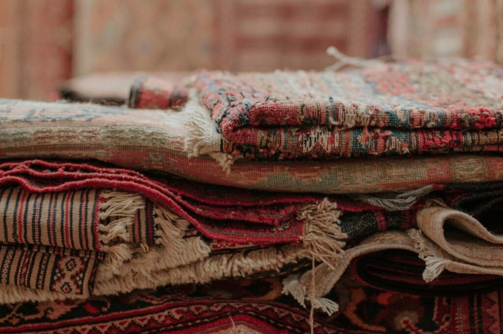 Pile of rugs stacked on top of each other
