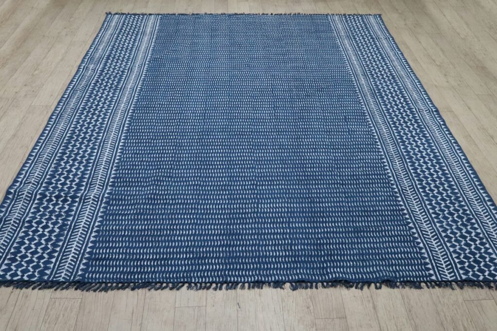 Blue and white striped rug on a wooden floor