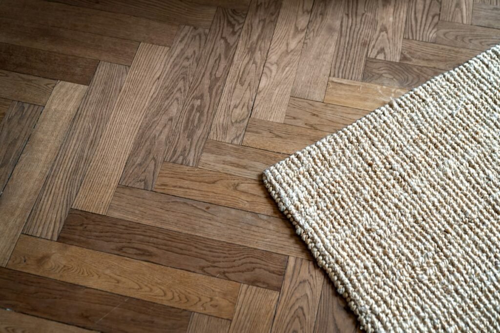 Close-up of a woven rug on a wooden floor