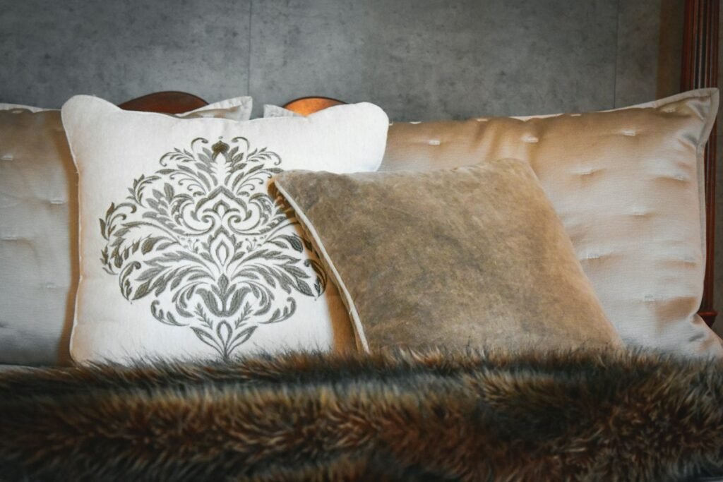 White and brown floral throw pillow on a brown sofa