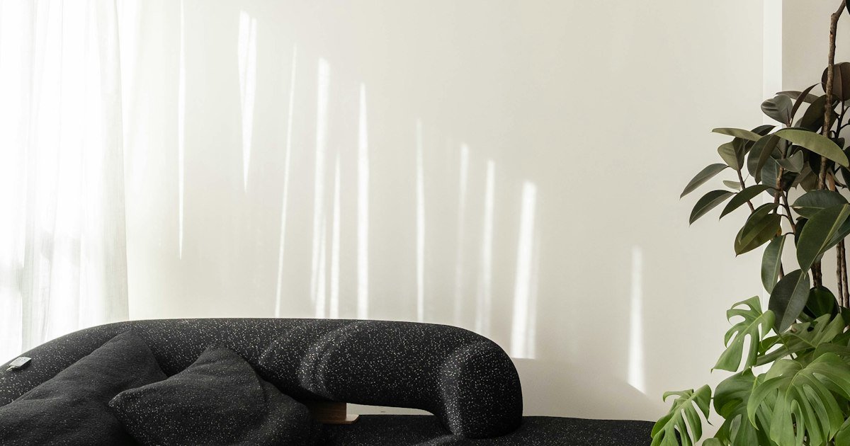 Mixed-pattern pillows on a black sofa