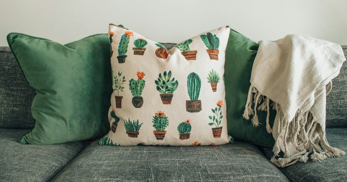 Pillows styled with a fringed throw blanket