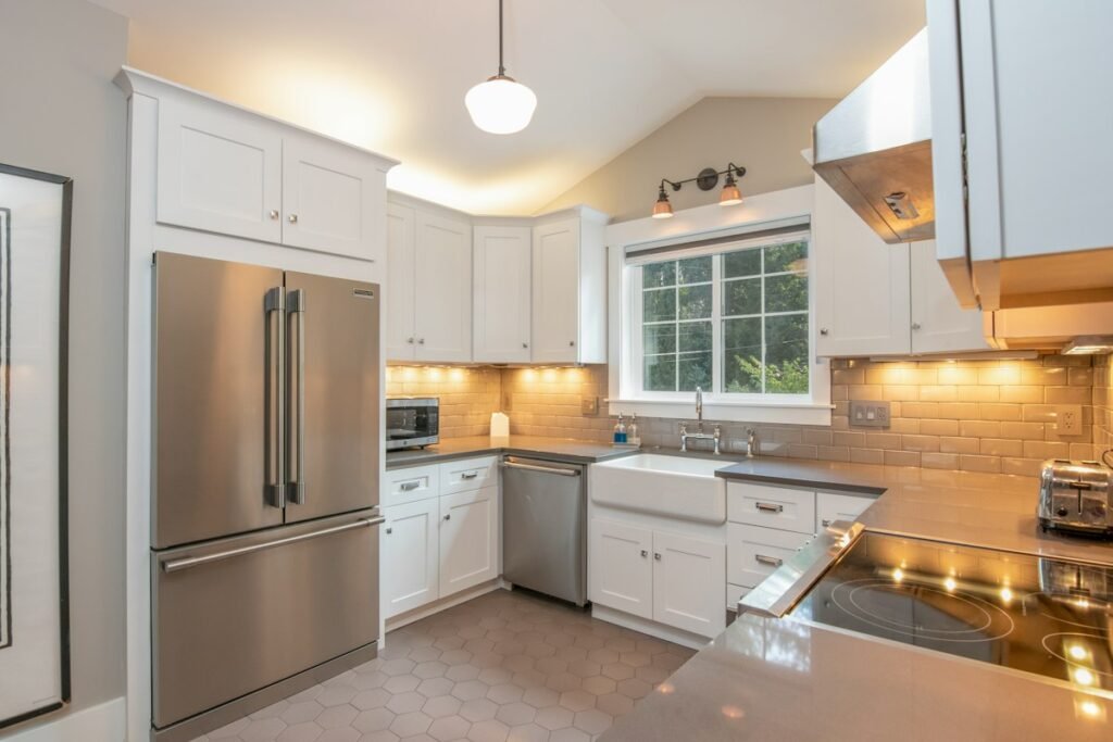 White kitchen cabinets with a white pendant lamp