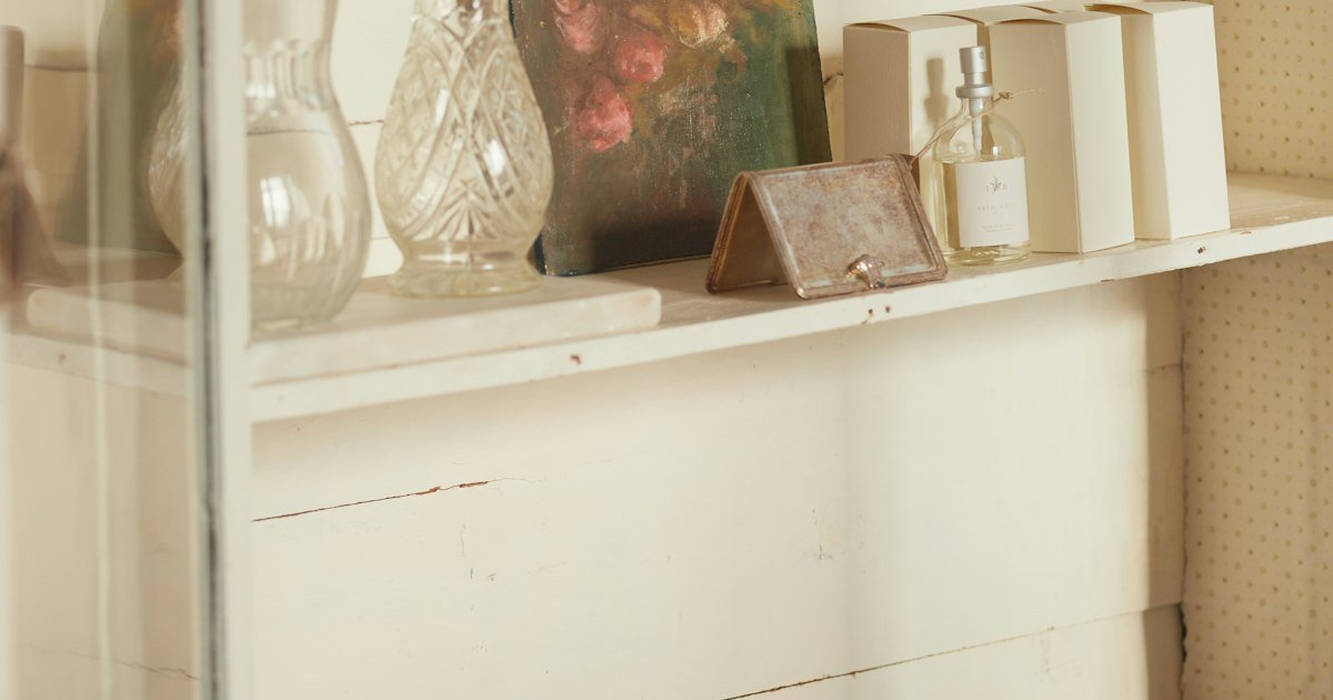 White cabinet styled with a row of vases