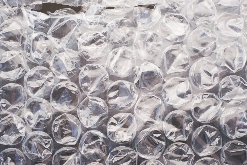 Bubble wrap home decor starts here: a close-up of clear polyethylene bubble wrap catching the light
