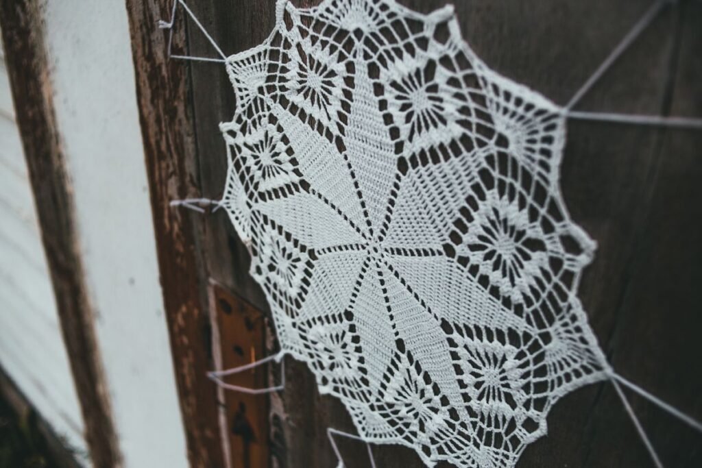 DIY doily wall decor: a handmade lace doily hung on a rustic wooden door
