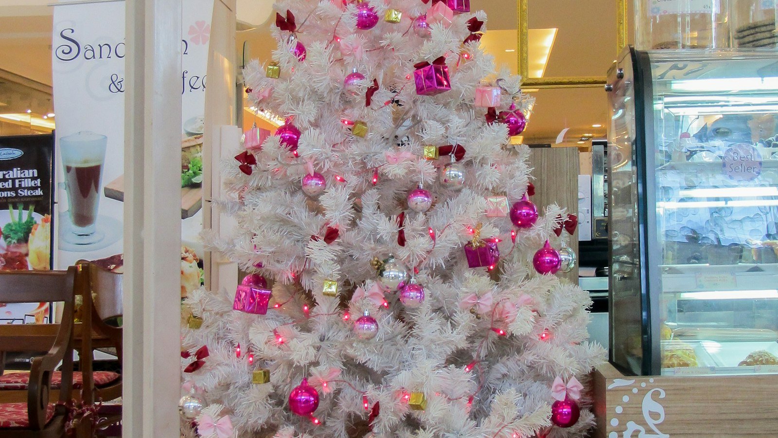 White tree with pink ornaments showing balanced pink Christmas decorations