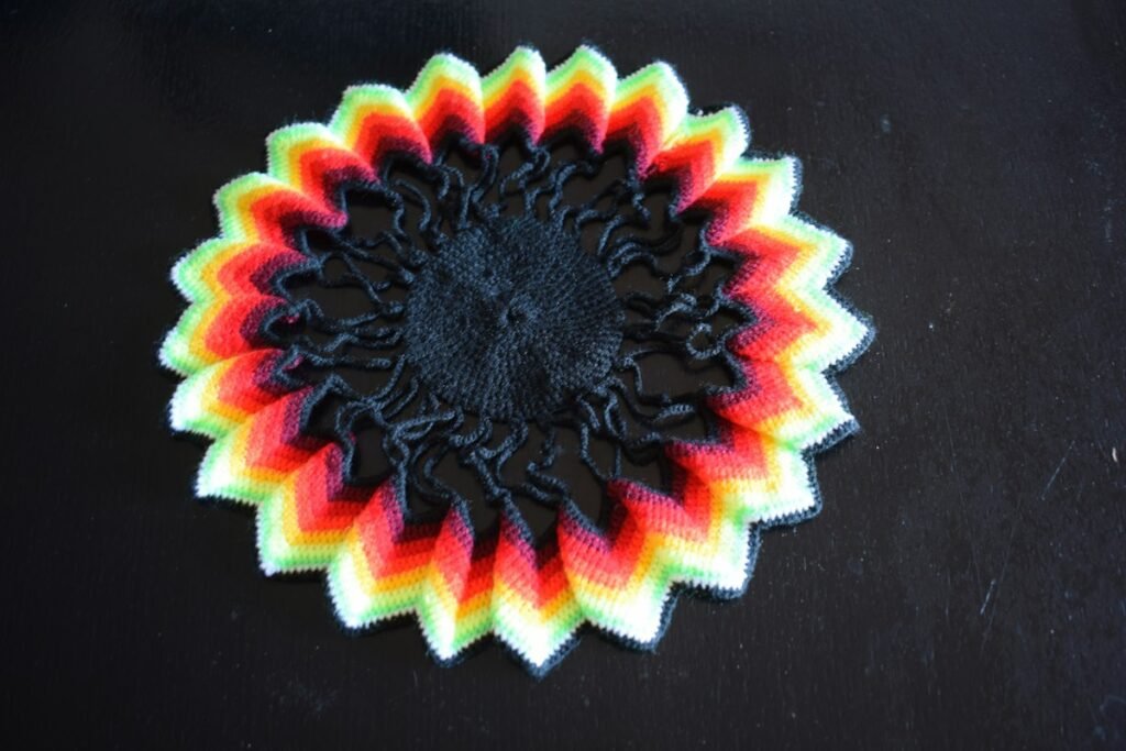 Round crochet doily with rainbow zigzag edges, a colorful option for doily wall art