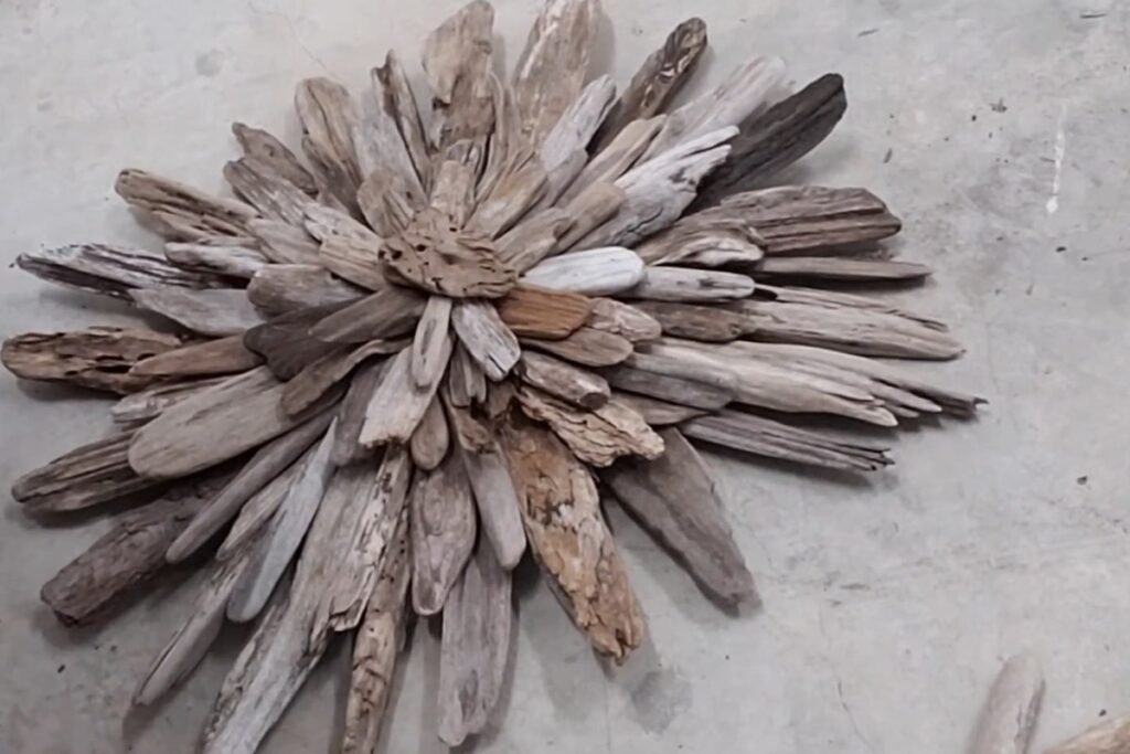 Finished layered driftwood starburst lying on a concrete floor