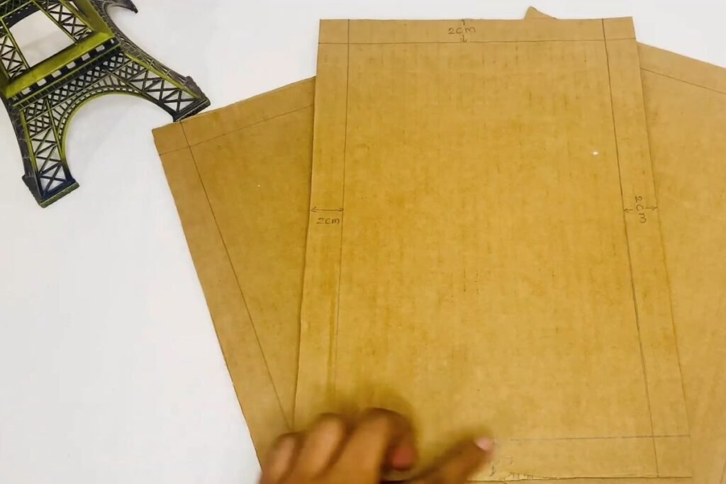 Cardboard sheets with a pencil border and 2 cm measurements written along the edges