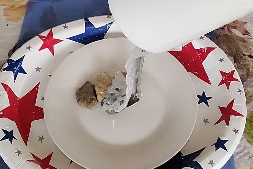 A strip of clear hot glue running from a white cup down to a saucer