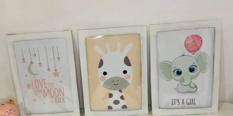 Three white DIY cardboard picture frames for nursery room wall decor, each holding a printed baby animal picture