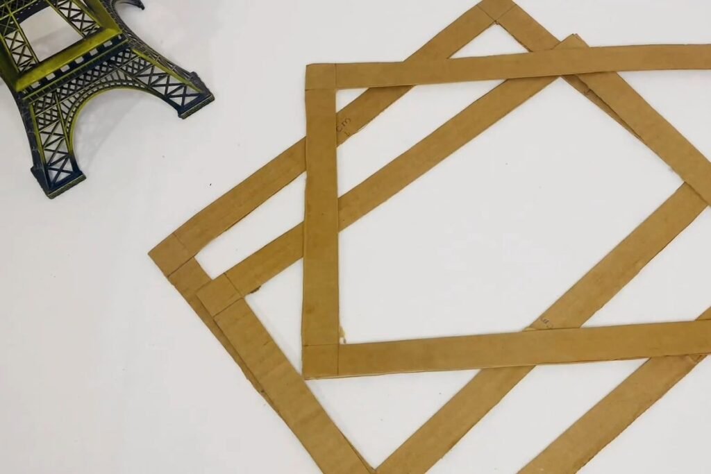 Two cut cardboard frame rings overlapping on a white table